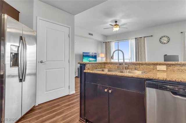 8255 Las Vegas Blvd Unit 719, Las Vegas, NV 89123 - kitchen featuring appliances with stainless steel finishes, a sink, dark wood-style flooring, ceiling fan, and light stone counters