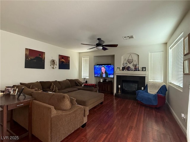 11457 Steponia Bay St, Las Vegas, NV 89141 - living room featuring wood finished floors, healthy amount of natural light, a ceiling fan, and a glass covered fireplace