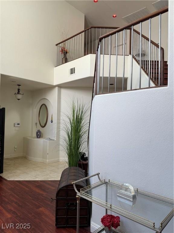 11457 Steponia Bay St, Las Vegas, NV 89141 - stairway with wood finished floors and a high ceiling
