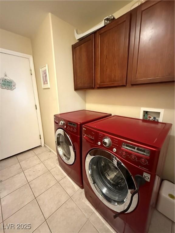 11457 Steponia Bay St, Las Vegas, NV 89141 - washroom featuring cabinet space, light tile patterned floors, and washer and clothes dryer