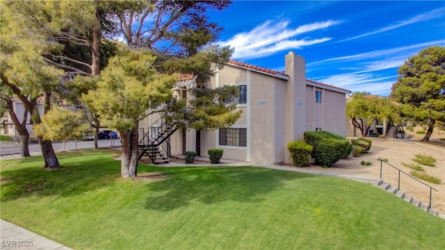1316 Capri Drive A,B,C,&D, Boulder City, NV 89005 - view of side of property with stairway, a chimney, a yard, and stucco siding