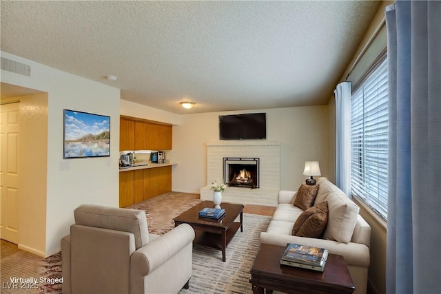 1316 Capri Drive A,B,C,&D, Boulder City, NV 89005 - living area featuring a textured ceiling, plenty of natural light, a fireplace, and light colored carpet