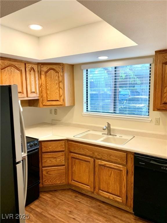 1316 Capri Drive A,B,C,&D, Boulder City, NV 89005 - kitchen with freestanding refrigerator, dishwasher, stove, a sink, and light wood-style floors