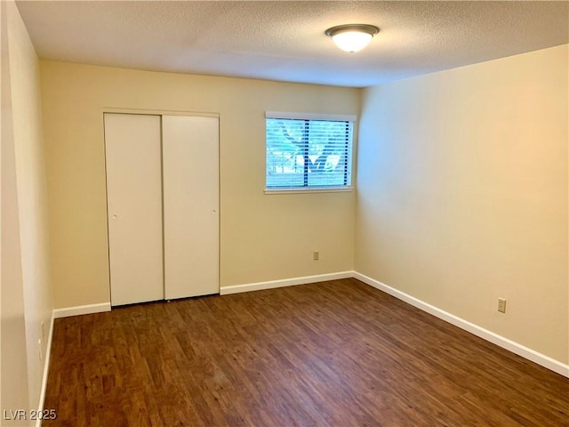 1316 Capri Drive A,B,C,&D, Boulder City, NV 89005 - unfurnished bedroom with wood finished floors, baseboards, a closet, and a textured ceiling