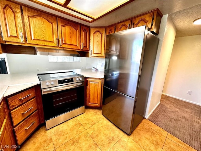 1316 Capri Drive A,B,C,&D, Boulder City, NV 89005 - kitchen featuring appliances with stainless steel finishes, brown cabinets, light countertops, light carpet, and light tile patterned floors