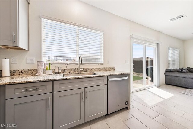 1885 Vass Springs Pl, North Las Vegas, NV 89084 - kitchen featuring dishwasher, gray cabinetry, and light stone counters