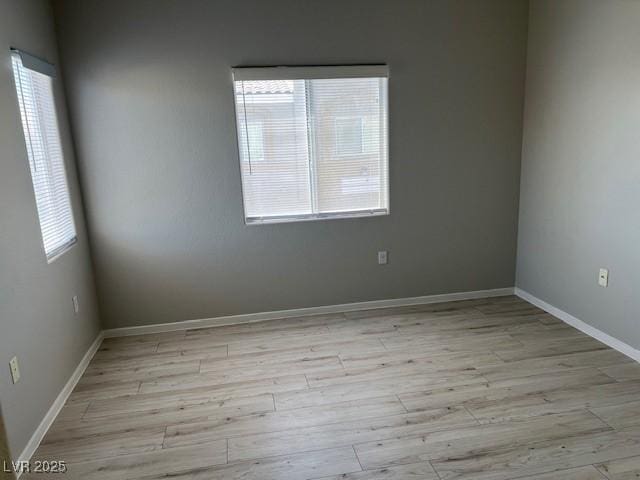 6170 E Sahara Ave Unit 1012, Las Vegas, NV 89142 - unfurnished room with healthy amount of natural light, light wood-style flooring, and baseboards