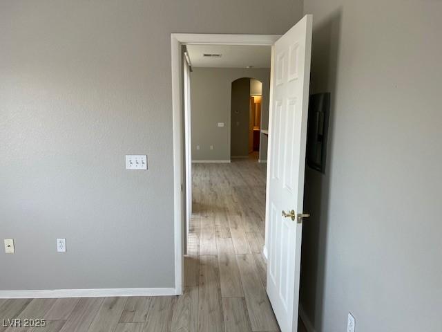 6170 E Sahara Ave Unit 1012, Las Vegas, NV 89142 - corridor featuring arched walkways, light wood finished floors, and baseboards