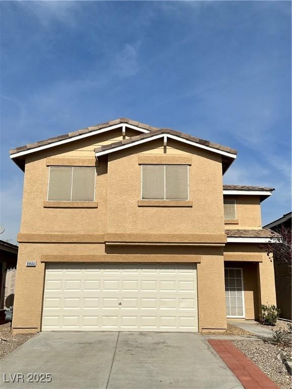 9844 Ashton Pines Ct, Las Vegas, NV 89147 - view of front of house with a garage, stucco siding, and concrete driveway