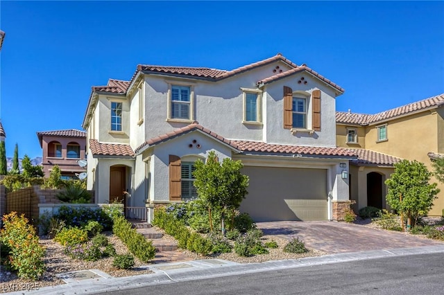 459 Astillero St, Las Vegas, NV 89138 - mediterranean / spanish home with a tile roof, an attached garage, stucco siding, and driveway