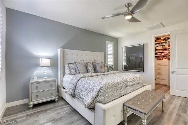 459 Astillero St, Las Vegas, NV 89138 - bedroom featuring a spacious closet, wood finished floors, a closet, ceiling fan, and baseboards