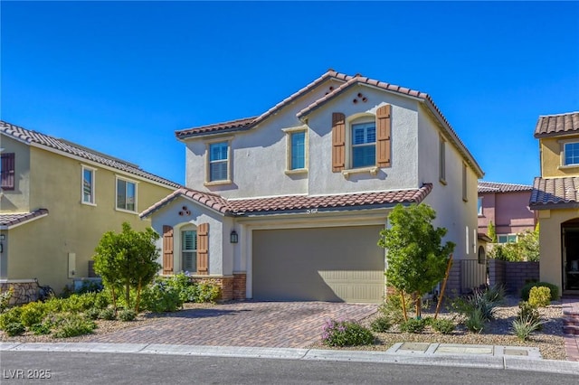 459 Astillero St, Las Vegas, NV 89138 - mediterranean / spanish home with stucco siding, a garage, a tile roof, and decorative driveway
