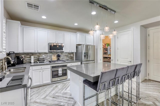 459 Astillero St, Las Vegas, NV 89138 - kitchen featuring appliances with stainless steel finishes, a sink, white cabinetry, backsplash, and recessed lighting