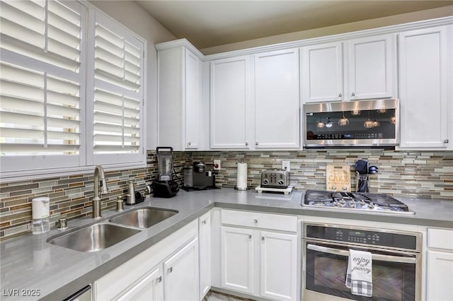 459 Astillero St, Las Vegas, NV 89138 - kitchen with appliances with stainless steel finishes, a sink, tasteful backsplash, and white cabinets