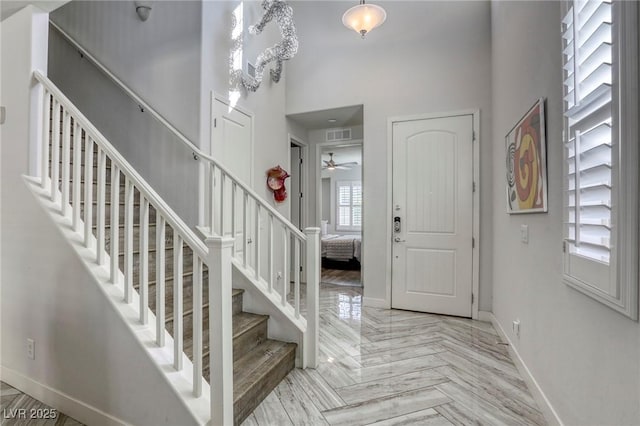 459 Astillero St, Las Vegas, NV 89138 - entryway featuring baseboards, a high ceiling, stairs, and a ceiling fan