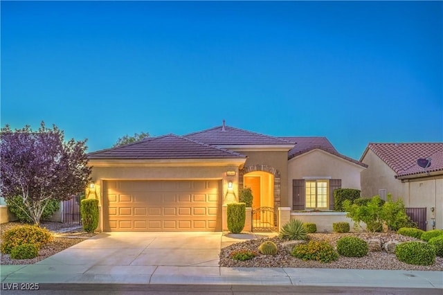 2144 Marywood Park Ct, Henderson, NV 89044 - view of front of house with a tiled roof, a garage, driveway, and stucco siding