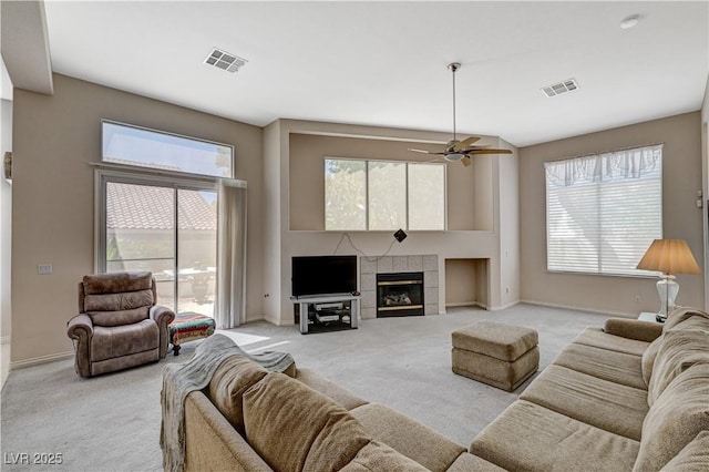 467 Beardsley Cir, Henderson, NV 89052 - living room with light colored carpet, baseboards, ceiling fan, and a fireplace