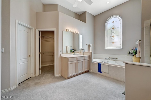 467 Beardsley Cir, Henderson, NV 89052 - bathroom with plenty of natural light, a ceiling fan, vanity, and a garden tub