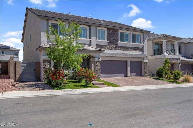 7260 Grace Estate Ave, Las Vegas, NV 89113 - townhome / multi-family property with an attached garage, stucco siding, decorative driveway, stone siding, and a gate