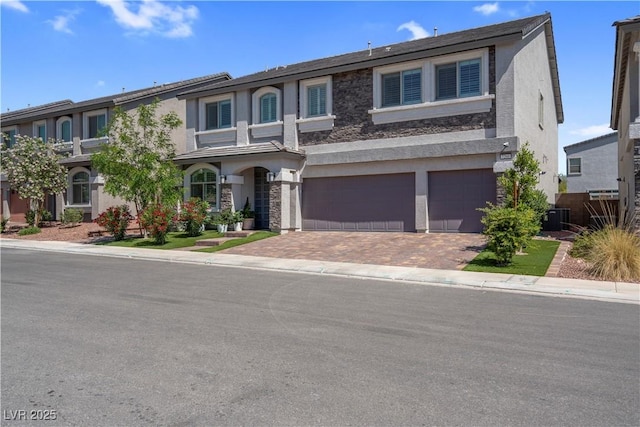 7260 Grace Estate Ave, Las Vegas, NV 89113 - view of front of property with stucco siding, an attached garage, decorative driveway, and central air condition unit