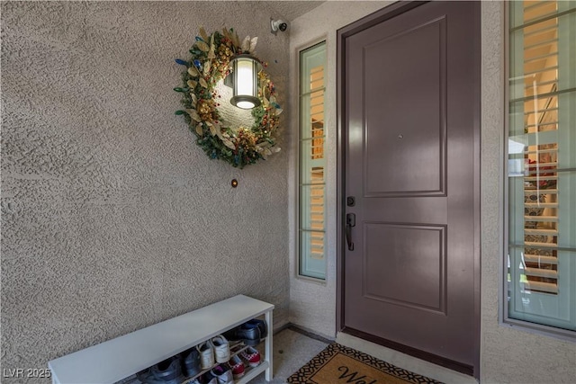 7260 Grace Estate Ave, Las Vegas, NV 89113 - view of exterior entry with stucco siding and a security system