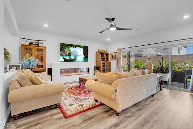 7260 Grace Estate Ave, Las Vegas, NV 89113 - living area featuring wood finished floors, a ceiling fan, a fireplace, and recessed lighting