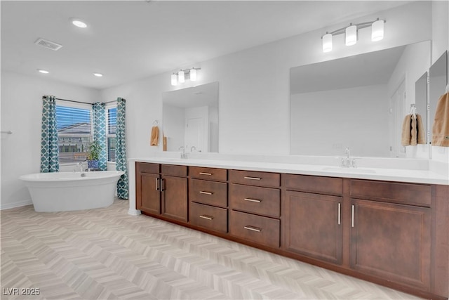 7260 Grace Estate Ave, Las Vegas, NV 89113 - bathroom featuring double vanity, a soaking tub, recessed lighting, and baseboards