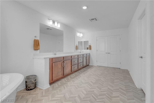 7260 Grace Estate Ave, Las Vegas, NV 89113 - full bath with double vanity, a freestanding bath, baseboards, and recessed lighting
