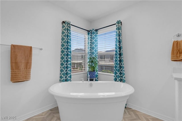 7260 Grace Estate Ave, Las Vegas, NV 89113 - bathroom with baseboards and a freestanding tub