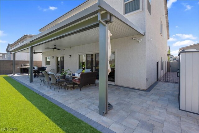 7260 Grace Estate Ave, Las Vegas, NV 89113 - view of patio / terrace featuring ceiling fan, a gate, an outdoor living space, and outdoor dining space