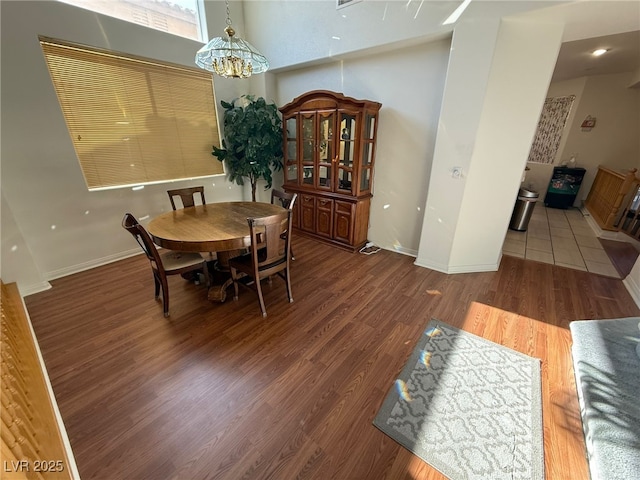 6351 Davidson Ct, Las Vegas, NV 89110 - dining room featuring a chandelier, wood finished floors, and baseboards