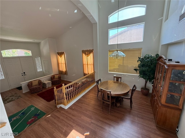 6351 Davidson Ct, Las Vegas, NV 89110 - dining space with a high ceiling, wood finished floors, a chandelier, and arched walkways
