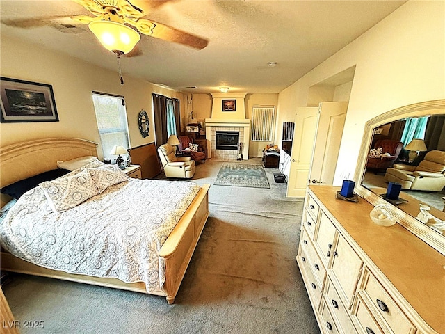 6351 Davidson Ct, Las Vegas, NV 89110 - bedroom featuring dark carpet, a fireplace, a textured ceiling, and ceiling fan