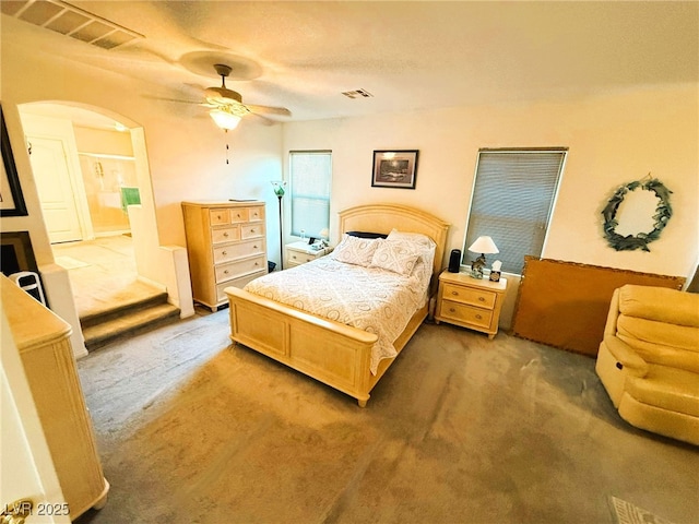 6351 Davidson Ct, Las Vegas, NV 89110 - carpeted bedroom featuring a ceiling fan and arched walkways