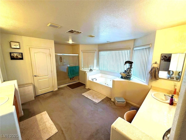 6351 Davidson Ct, Las Vegas, NV 89110 - full bathroom featuring double vanity, a shower stall, a bath, and a textured ceiling