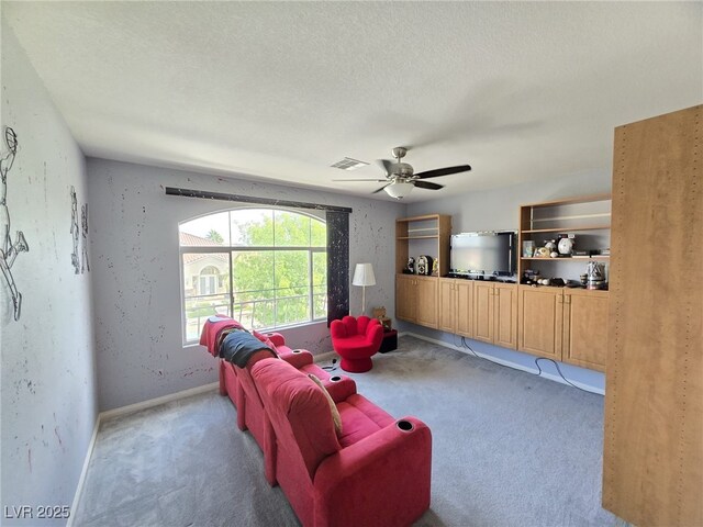 6351 Davidson Ct, Las Vegas, NV 89110 - carpeted living room with a ceiling fan, baseboards, and a textured ceiling