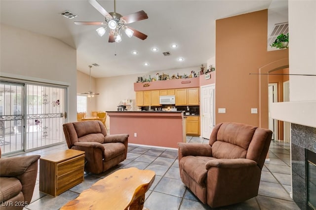 1017 Guided Dancer Ave, Henderson, NV 89015 - living area featuring ceiling fan, high vaulted ceiling, light tile patterned floors, recessed lighting, and a fireplace