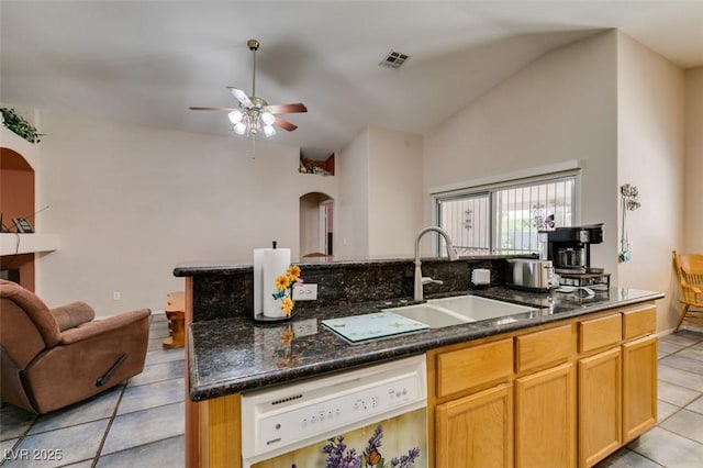 1017 Guided Dancer Ave, Henderson, NV 89015 - kitchen with dishwasher, a sink, arched walkways, light tile patterned floors, and lofted ceiling