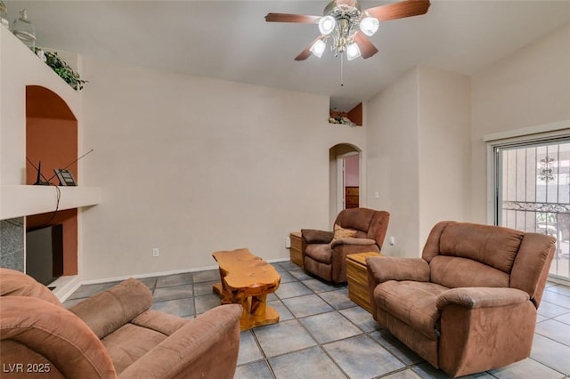 1017 Guided Dancer Ave, Henderson, NV 89015 - living room featuring arched walkways, a ceiling fan, and light tile patterned floors