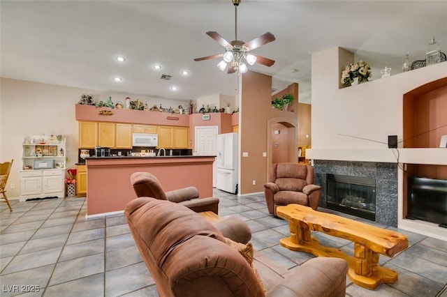 1017 Guided Dancer Ave, Henderson, NV 89015 - living room with ceiling fan, arched walkways, a premium fireplace, high vaulted ceiling, and recessed lighting