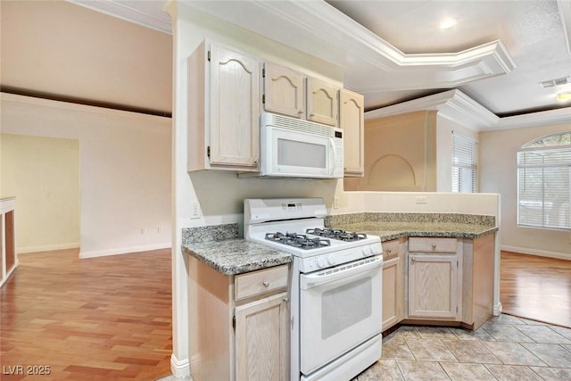 8725 Red Rio Dr Unit 203, Las Vegas, NV 89128 - kitchen with white appliances, crown molding, light wood-type flooring, a raised ceiling, and a peninsula