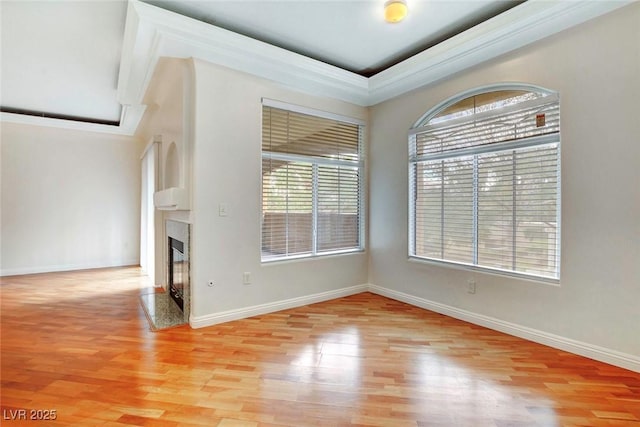 8725 Red Rio Dr Unit 203, Las Vegas, NV 89128 - unfurnished living room with light wood finished floors, a fireplace, baseboards, and crown molding
