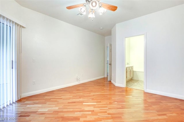 8725 Red Rio Dr Unit 203, Las Vegas, NV 89128 - unfurnished bedroom with light wood-type flooring, baseboards, connected bathroom, vaulted ceiling, and a ceiling fan