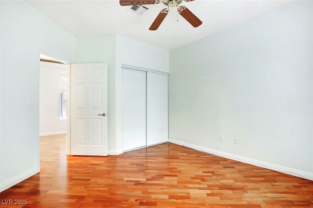 8725 Red Rio Dr Unit 203, Las Vegas, NV 89128 - unfurnished bedroom with light wood-style floors, baseboards, a closet, and ceiling fan