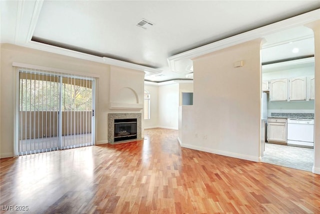 8725 Red Rio Dr Unit 203, Las Vegas, NV 89128 - unfurnished living room with light wood finished floors, baseboards, ornamental molding, and a fireplace with flush hearth