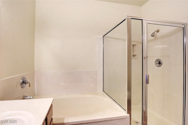 8725 Red Rio Dr Unit 203, Las Vegas, NV 89128 - bathroom featuring a shower stall, a garden tub, and vanity