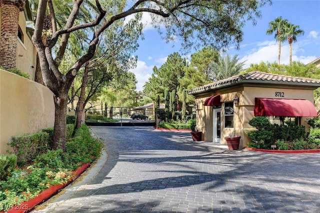 8725 Red Rio Dr Unit 203, Las Vegas, NV 89128 - view of street featuring a gate and curbs