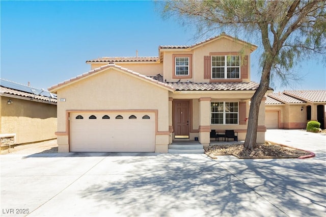 561 Fork Mesa Ct, Henderson, NV 89015 - mediterranean / spanish house featuring stucco siding, a tile roof, concrete driveway, and an attached garage