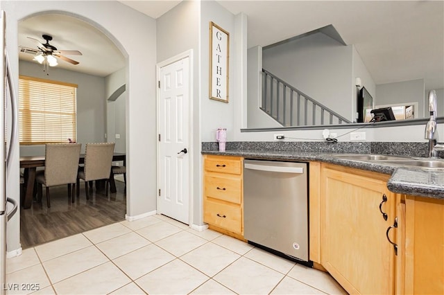 561 Fork Mesa Ct, Henderson, NV 89015 - kitchen featuring stainless steel dishwasher, light brown cabinetry, ceiling fan, light tile patterned floors, and a sink