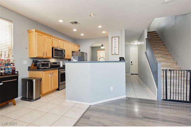 561 Fork Mesa Ct, Henderson, NV 89015 - kitchen with appliances with stainless steel finishes, light brown cabinets, dark countertops, recessed lighting, and healthy amount of natural light